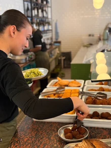 A member of the team serving at the counter