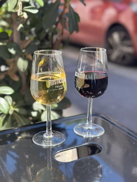 A glass of white and a glass of red wine on the terrace