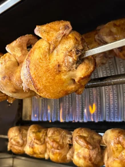 Chicken turning on the rotisserie spit